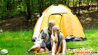 Older Men And Younger Women Enjoy A Picnic